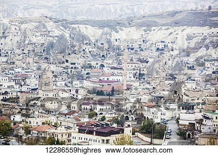 Stock Photograph - Houses and man-made cave dwellings; Goreme, Cappadocia, Turkey. Fotosearch