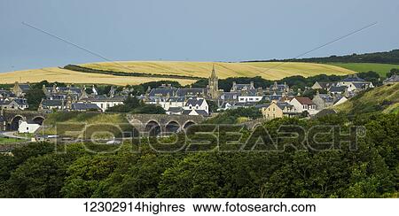 Houses in a town in the Highlands with farmland in the distance; Cullen, Moray, Scotland View Large Photo Image Stock Photograph - Houses in a town in the Highlands with farmland in the distance; Cullen, Moray, Scotland. Fotosearch