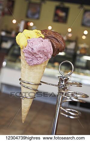 Ice cream cone with three different flavours of ice cream; Quebec, Canada View Large Photo Image Stock Photograph - Ice cream cone with three different flavours of ice cream; Quebec, Canada. Fotosearch