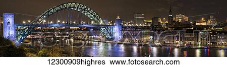 Stock Photograph - Illuminated Tyne bridge over the River Tyne at nighttime; Newcastle, Tyne and Wear, England. Fotosearch