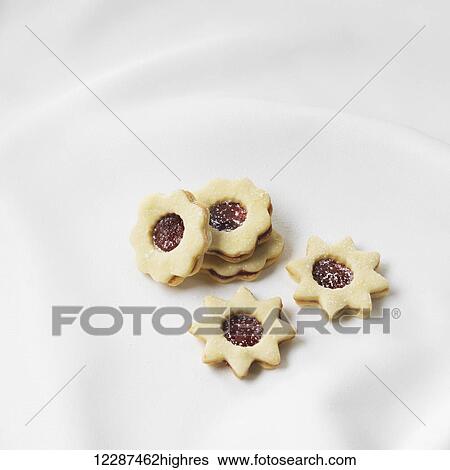 Jam filled cookies in the shape of stars and flowers; Toronto, Ontario, Canada View Large Photo Image Stock Photograph - Jam filled cookies in the shape of stars and flowers; Toronto, Ontario, Canada. Fotosearch