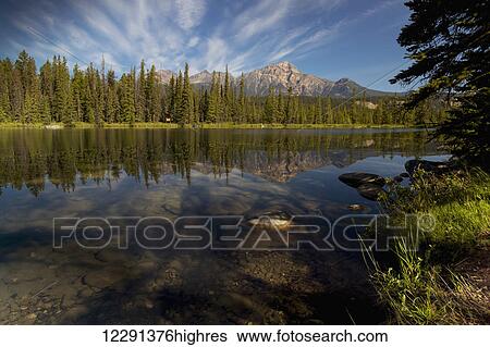 Stock Photograph - Jasper Park Lodge with Pyramid mountain in the distance, Jasper National Park; Alberta, Canada. Fotosearch