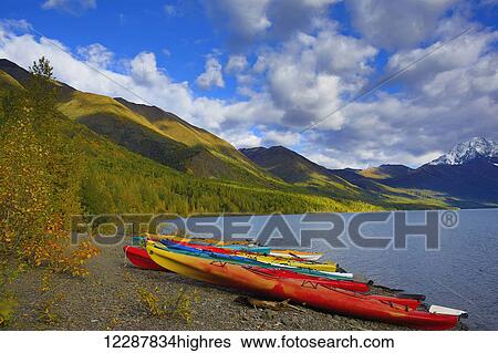 Stock Photograph - Kayaks on the shore of Eklutna Lake in autumn, Chugach State Park, South-central Alaska. Fotosearch
