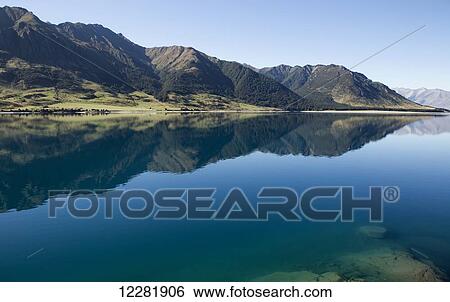 Lake Hawea with reflections of mountains; South Island, New Zealand View Large Photo Image Stock Photograph - Lake Hawea with reflections of mountains; South Island, New Zealand. Fotosearch