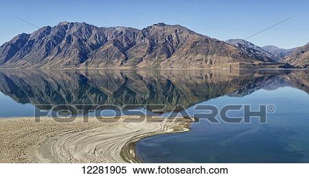 Stock Photography - Lake Hawea with reflections of mountains; South Island, New Zealand. Fotosearch