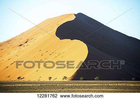 Stock Image - Large desert sand dunes; Sossusvlei, Namibia. Fotosearch