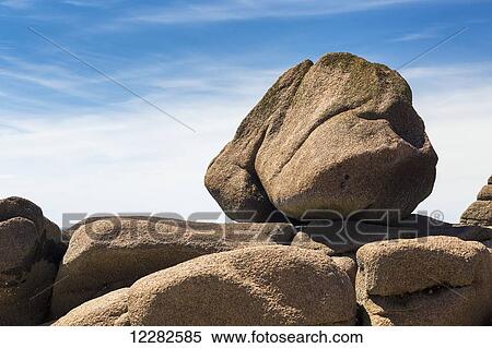 Large round rock balanced on rock formation with blue sky and clouds; Trebeurden, Brittany, France View Large Photo Image Stock Photography - Large round rock balanced on rock formation with blue sky and clouds; Trebeurden, Brittany, France. Fotosearch
