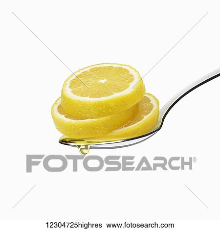 Lemon slices on a spoon on a white background with a liquid droplet falling; Toronto, Ontario, Canada View Large Photo Image Stock Photograph - Lemon slices on a spoon on a white background with a liquid droplet falling; Toronto, Ontario, Canada. Fotosearch