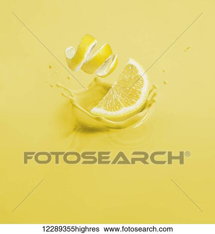 Lemon wedge and curled peel dropping into yellow liquid; Toronto, Ontario, Canada View Large Photo Image Stock Photograph - Lemon wedge and curled peel dropping into yellow liquid; Toronto, Ontario, Canada. Fotosearch