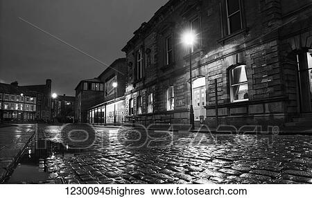 Light from a lamp post illuminating wet cobblestone road; South Shields, Tyne and Wear, England View Large Photo Image Stock Photograph - Light from a lamp post illuminating wet cobblestone road; South Shields, Tyne and Wear, England. Fotosearch