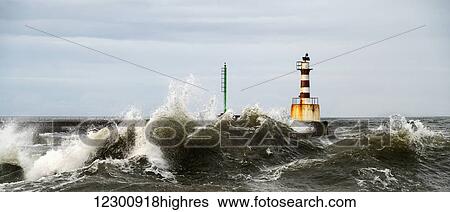 Lighthouse and splashing waves; Amble, Northumberland, England View Large Photo Image Stock Photograph - Lighthouse and splashing waves; Amble, Northumberland, England. Fotosearch