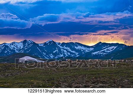 Stock Photograph - Lightning strikes over the Never Summer Mountains during a summer thunderstorm in Rocky Mountain National Park; Colorado, United States of America. Fotosearch