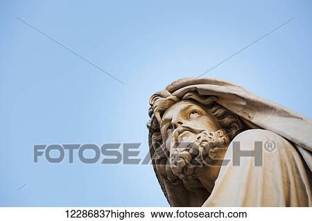Low angle view of statue of male figure against a blue sky; Rome, Italy View Large Photo Image Stock Photograph - Low angle view of statue of male figure against a blue sky; Rome, Italy. Fotosearch