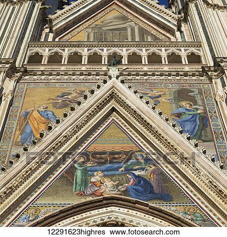 Low angle view of the colourful painted facade of Orvieto Cathedral; Orvieto, Umbria, Italy View Large Photo Image Stock Photograph - Low angle view of the colourful painted facade of Orvieto Cathedral; Orvieto, Umbria, Italy. Fotosearch