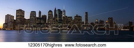Stock Photograph - Lower Manhattan skyline at sunset; New York City, New York, United States of America. Fotosearch