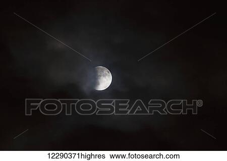 Lunar eclipse, viewed through passing clouds; Brampton, Ontario, Canada View Large Photo Image Stock Photograph - Lunar eclipse, viewed through passing clouds; Brampton, Ontario, Canada. Fotosearch