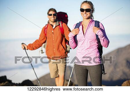 Man and woman hiking on beautiful mountain trail. Trekking and backpacking in the mountains. Healthy lifestyle outdoor adventure concept. View Large Photo Image Stock Photograph - Man and woman hiking on beautiful mountain trail. Trekking and backpacking in the mountains. Healthy lifestyle outdoor adventure concept.. Fotosearch