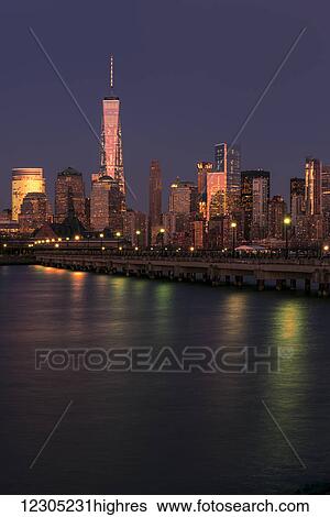 Stock Photograph - Manhattan skyline at sunset, Liberty State Park; Jersey City, New Jersey, United States of America. Fotosearch