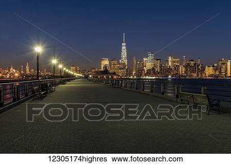 Stock Photograph - Manhattan skyline at twilight, Liberty State Park; Jersey City, New Jersey, United States of America. Fotosearch