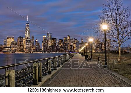 Stock Photograph - Manhattan skyline at twilight, Liberty State Park; Jersey City, New Jersey, United States of America. Fotosearch