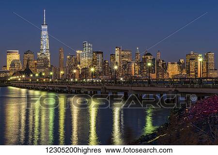 Stock Photograph - Manhattan skyline at twilight, Liberty State Park; Jersey City, New Jersey, United States of America. Fotosearch
