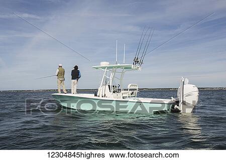 Men standing on the end of a fishing boat and fishing in the Atlantic Ocean off the coast of Cape Cod; Massachusetts, United States of America View Large Photo Image Stock Photograph - Men standing on the end of a fishing boat and fishing in the Atlantic Ocean off the coast of Cape Cod; Massachusetts, United States of America. Fotosearch