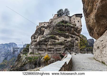 Stock Photograph - Monastery perched on a cliff; Meteora, Greece. Fotosearch
