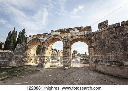 Stock Photograph - Monumental entrance to the Roman city of Pamukkale; Pamukkale, Turkey. Fotosearch
