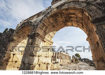 Stock Photograph - Monumental entrance to the Roman city of Pamukkale; Pamukkale, Turkey. Fotosearch