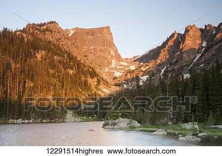 Stock Photograph - Morning light on Hallett Peak at Nymph Lake in Rocky Mountain National Park; Colorado, United States of America. Fotosearch