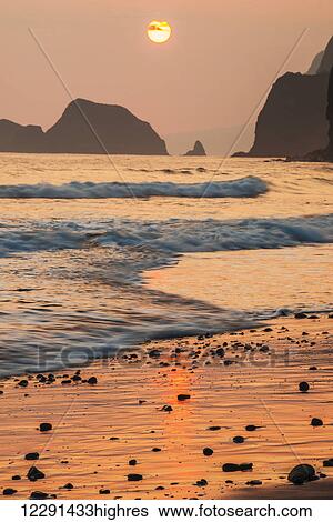 Stock Photograph - Morning sun and surf at Pololu Valley; Island of Hawaii, Hawaii, United States of America. Fotosearch