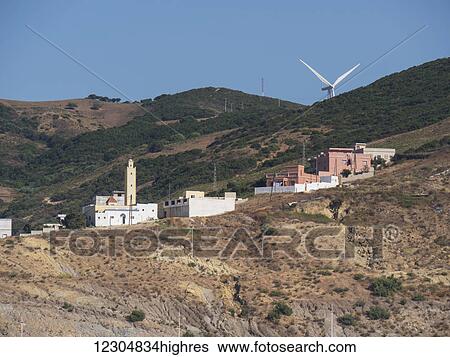 Mosque and wind turbine on the hillside above the Mediterranean port; Tangier, Morocco View Large Photo Image Stock Photograph - Mosque and wind turbine on the hillside above the Mediterranean port; Tangier, Morocco. Fotosearch
