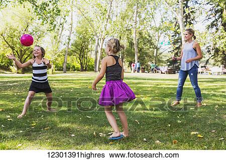 Mother and daughters throwing a ball in a park during a family outing; Edmonton, Alberta, Canada View Large Photo Image Stock Photograph - Mother and daughters throwing a ball in a park during a family outing; Edmonton, Alberta, Canada. Fotosearch