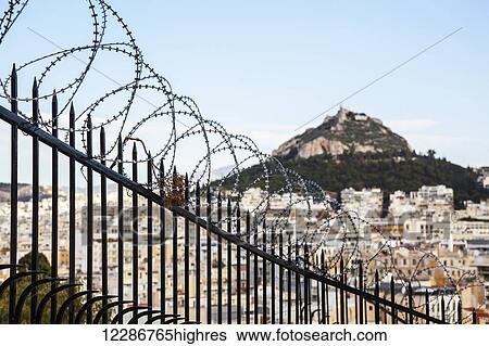 Mount Lycabettus and a barbed wire fence; Athens, Greece View Large Photo Image Stock Photograph - Mount Lycabettus and a barbed wire fence; Athens, Greece. Fotosearch