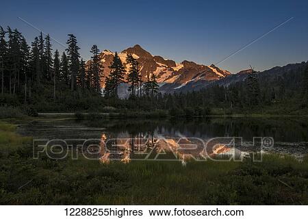 Stock Photograph - Mt. Shuksan is reflected in the waters of Picture Lake; Washington State, United States of America. Fotosearch