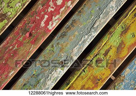 Stock Photograph - Multi-coloured distressed chair back at an angle; Athens, Attica, Greece. Fotosearch