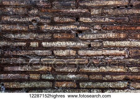 Stock Photograph - Names defacing a stone wall, Colosseum; Rome, Italy. Fotosearch
