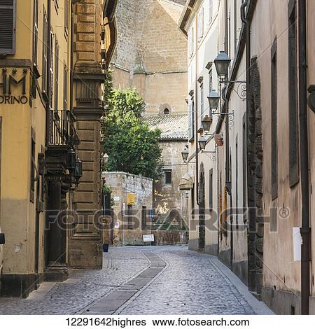 Narrow street between colourful buildings; Orvieto, Umbria, Italy View Large Photo Image Stock Photograph - Narrow street between colourful buildings; Orvieto, Umbria, Italy. Fotosearch