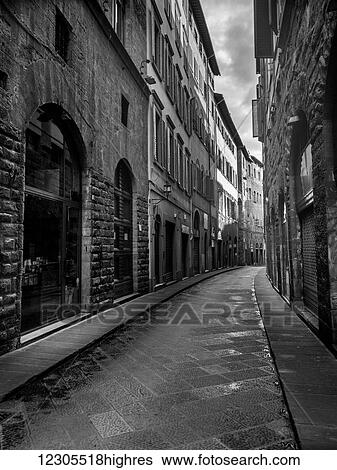 Stock Photograph - Narrow street between residential buildings; Florence, Italy. Fotosearch