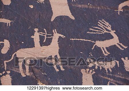Stock Photograph - Newspaper Rock Petroglyph, etched in the rock from approximately 700 BC through 1300 AD, South of Moab; Utah, United States of America. Fotosearch