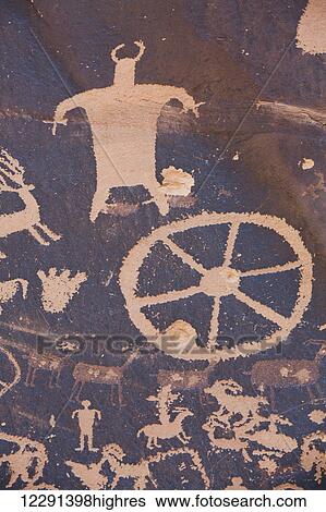 Stock Photograph - Newspaper Rock Petroglyph, etched in the rock from approximately 700 BC through 1300 AD, South of Moab; Utah, United States of America. Fotosearch