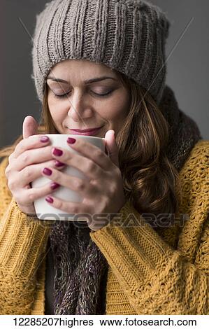 Stock Photograph - Nicaraguan woman drinking a cup of tea; Toronto, Ontario, Canada. Fotosearch
