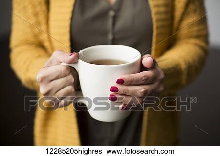 Nicaraguan woman holding a cup of tea; Toronto, Ontario, Canada View Large Photo Image Stock Photograph - Nicaraguan woman holding a cup of tea; Toronto, Ontario, Canada. Fotosearch