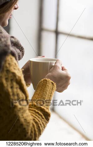 Nicaraguan woman holding a cup of tea and looking out the window; Toronto, Ontario, Canada View Large Photo Image Stock Photograph - Nicaraguan woman holding a cup of tea and looking out the window; Toronto, Ontario, Canada. Fotosearch