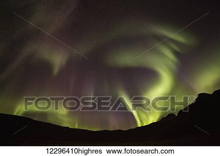 Northern Lights, or Aurora Borealis, glowing red and green over the silhouetted landscape; Iceland View Large Photo Image Stock Photograph - Northern Lights, or Aurora Borealis, glowing red and green over the silhouetted landscape; Iceland. Fotosearch