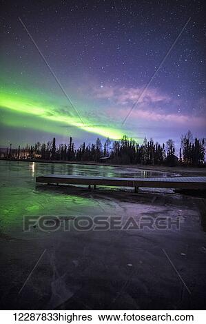 Stock Photograph - Northern lights over Big Lake North State Recreational Site, Southcentral Alaska. Fotosearch