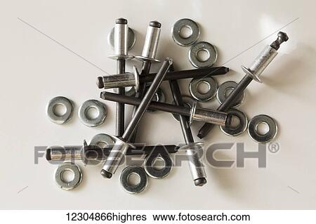 Stock Photograph - Nuts and bolts with patterns and shadows; Chilliwack, British Columbia, Canada. Fotosearch
