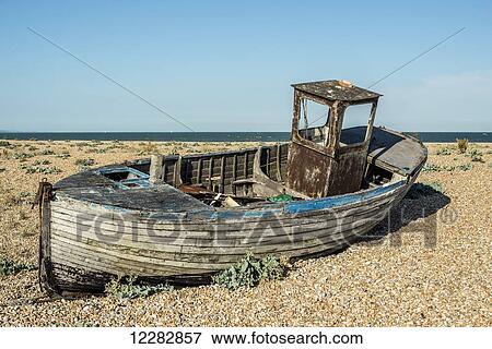 Stock Photo - Old boat on Dungeness shingle beach; Dungeness, Kent, England. Fotosearch