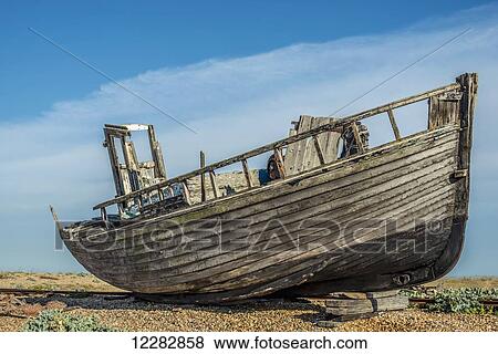Old boat on Dungeness shingle beach; Dungeness, Kent, England View Large Photo Image Stock Photo - Old boat on Dungeness shingle beach; Dungeness, Kent, England. Fotosearch
