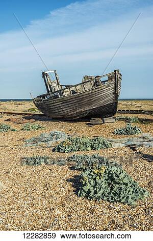 Stock Photo - Old boat on Dungeness shingle beach; Dungeness, Kent, England. Fotosearch